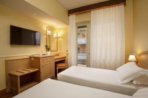 Postel nebo postele na pokoji v ubytování Hotel Santa Costanza by OMNIA hotels