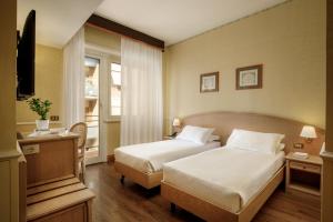 Postel nebo postele na pokoji v ubytování Hotel Santa Costanza by OMNIA hotels