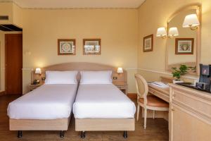 Postel nebo postele na pokoji v ubytování Hotel Santa Costanza by OMNIA hotels