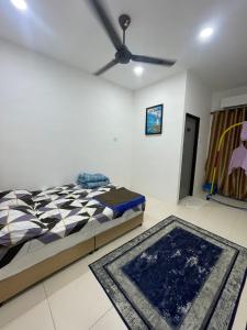 a bedroom with a bed and a ceiling fan at HV SENCHO HOMESTAY House Vessel Sencho Home of Nautical Decoration in Temerloh
