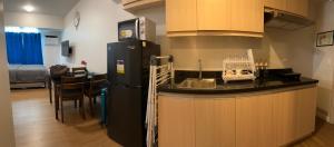 a kitchen with a black refrigerator in a room at Solinea Residences 30thfloor Tower4 Ayala Business Center Cebu ph in Cebu City