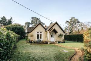 a small white house with a yard at Badgemore Cottage in Henley on Thames