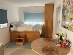 a small bedroom with a bed and a table at Iris privet room in Mevasseret Zion