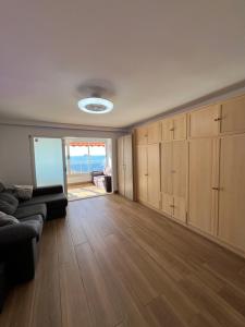 a living room with a couch and wooden cabinets at Hany apartment Ducado 12-E in Benidorm