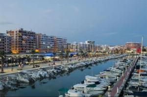 a group of boats docked in a marina in a city at PosadaLux Carmen 4Pax in Santa Pola