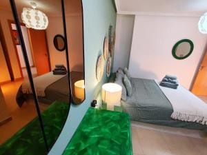 a room with two beds and a mirror at PosadaLux Carmen 4Pax in Santa Pola