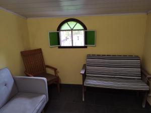 a living room with a couch and a window at Pousada Bela Vista 1 in Petrópolis