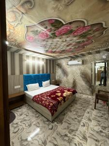 a bedroom with a bed with flowers painted on the ceiling at Tejas dream house 4 minute away from Golden Temple in Amritsar