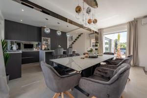 a kitchen and dining room with a table and chairs at Beautiful Villa Tyara in Zaton