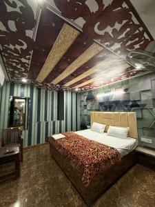 a bedroom with a large bed with a leopard print bedspread at Tejas dream house 4 minute away from Golden Temple in Amritsar