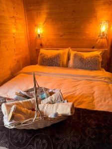 a bed with a basket of towels on it at Drveni san Senović 2 in Banja +37 photos