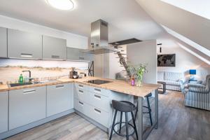 a kitchen with white cabinets and a wooden counter top at Quartier am weißen Gold in Meißen