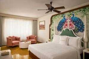 a hotel room with a bed and a chair at Storii By ITC Hotels, Jaisalmer in Jaisalmer