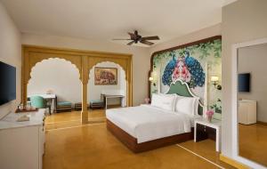 a bedroom with a bed and a painting on the wall at Storii By ITC Hotels, Jaisalmer in Jaisalmer