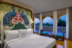 a bedroom with a bed with a painting on the wall at Storii By ITC Hotels, Jaisalmer in Jaisalmer