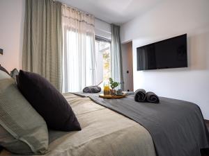 a bedroom with a bed with a flat screen tv at Casa Dea in Malinska +50 photos