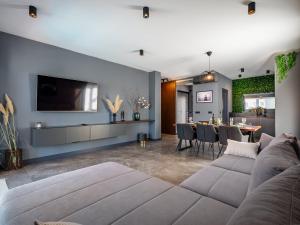 a living room with a couch and a dining room at Casa Dea in Malinska