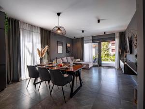 a dining room and living room with a table and chairs at Casa Dea in Malinska