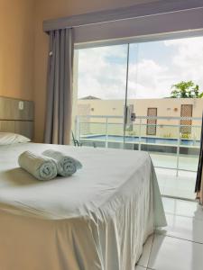 a bedroom with a bed with a large window at Hotel Costa do Delta in Tutóia +62 photos