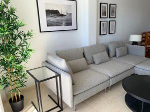 a living room with a couch and a table at Panoramic Sea Views with Balcony, Air Conditioning and Parking in Aguadulce