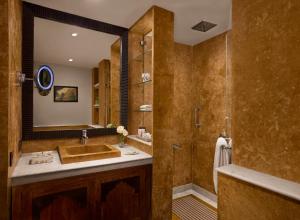 a bathroom with a sink and a shower with a mirror at Storii By ITC Hotels, Jaisalmer in Jaisalmer