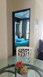 a room with a glass table and a mirror at Jev Penthouse in Port Dickson