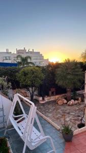a pair of white lawn chairs sitting on a patio at Luxury Estudio CH&H in Benalmádena