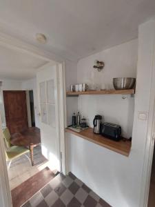 a small kitchen with a counter and a chair at Cosy appartment in Arnhem +2 photos