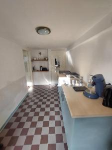 a kitchen with a checkered floor and a counter top at Cosy appartment in Arnhem