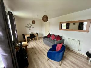 a living room with a couch and a table at Meadowside Apartment - Part of the The Bay Filey Holiday Village with pool, gym and direct beach access, pub, restaurant, tennis and meadows walks in Filey