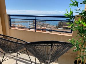a black chair on a balcony with a view of the ocean at Panoramic Sea Views with Balcony, Air Conditioning and Parking in Aguadulce