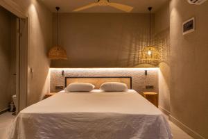 a bedroom with a white bed with two pillows at Sea Soul Hotel in Bodrum City