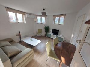 a living room with a couch and a table at Cosy appartment in Arnhem