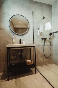 a bathroom with a sink and a mirror at Hotel U Racka in Ostrožská Nová Ves +52 photos