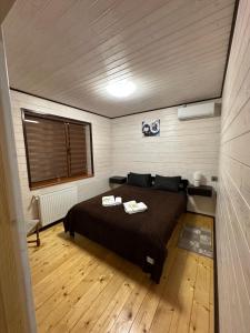 a bedroom with a large bed in a room at Приватна садиба ~Smoky mountain~ in Polyana +28 photos