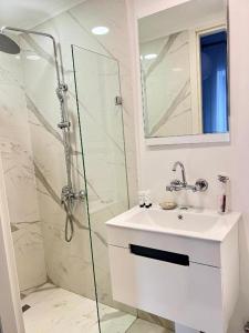 a bathroom with a shower and a sink and a mirror at Opera Boutique Hotel in Tbilisi City +39 photos