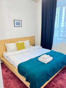 a bedroom with a bed with two towels on it at Opera Boutique Hotel in Tbilisi City