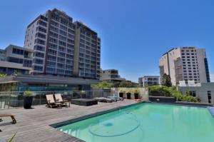 a large swimming pool on top of a building at 801 Infinity 2 Bedroom Beachfront Apartment in Cape Town