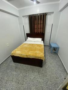 a bedroom with a bed and a blue table at Tokyo House Luxor in Luxor