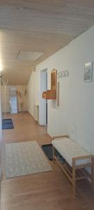 a living room with a bed and a wooden floor at Ferienwohnung Meusburger in Hittisau