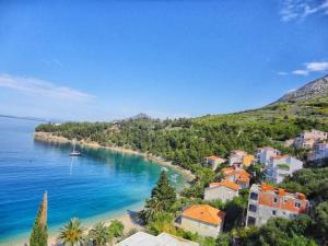 a view of a beach with a boat in the water at Apartments Karla in Stanići