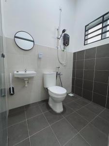 a bathroom with a toilet and a sink at Haneya Homestay in Kampong Banggol Pasir +11 photos