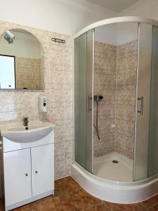 a bathroom with a shower and a sink at Penzión Centrum in Terchová +18 photos