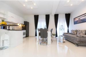 a living room with a couch and a table at Apartments & Rooms Jure in Viniština