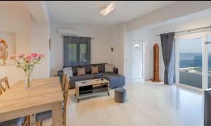 a living room with a couch and a table at Villa Neli I in Achlia
