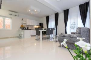 a living room with a couch and a table at Apartments & Rooms Jure in Viniština +33 photos