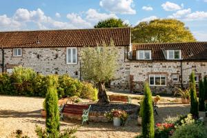 a stone house with a garden in front of it at Swingletree Cottage in Bridlington