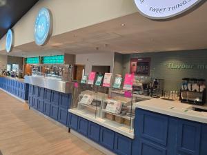 a store with blue cabinets and a food counter at Billing Aquadrome Holiday Park in Great Billing