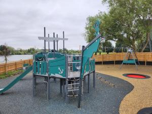 a playground with a slide and a swing at Billing Aquadrome Holiday Park in Great Billing