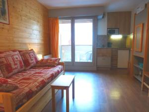 a living room with a couch and a kitchen at Studio cosy pour 4 pers, centre-ville de Brides-les-Bains, WIFI, animaux admis - FR-1-512-157 in Brides-les-Bains